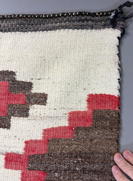 Navajo regional rug featuring a striking all-over geometric diamond composition