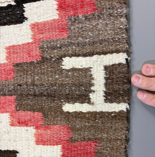 Navajo regional rug featuring a striking all-over geometric diamond composition